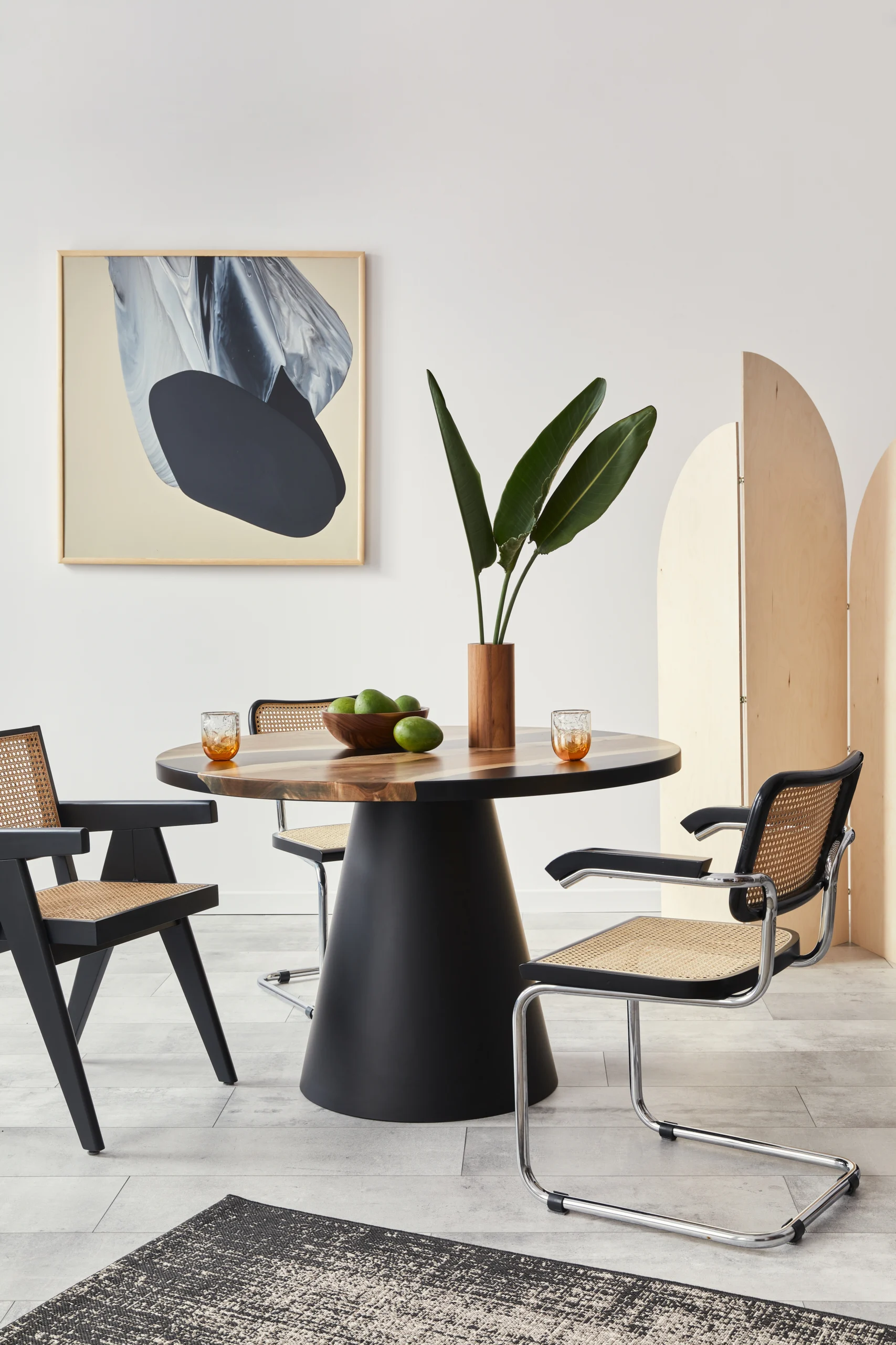 stylish-composition-dining-room-interior-with-design-table-modern-chairs-decoration-tropical-leaf-vase-fruits-carpet-abstract-paintings-elegant-accessories-home-decor